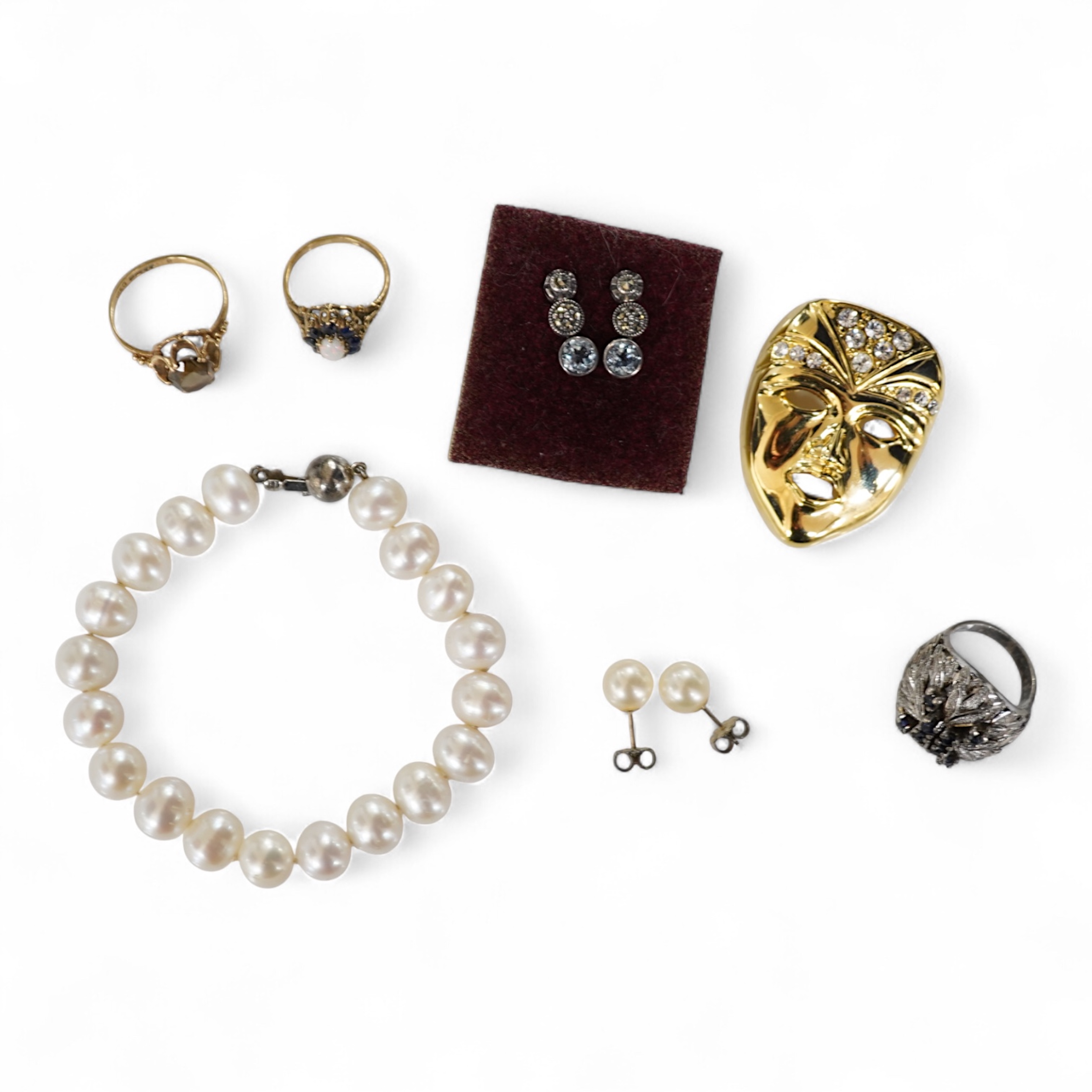 A collection of jewels, comprising: an opal and sapphire cluster ring and a citrine ring in 9ct gold, each with British hallmarks, combined gross weight approximately 4 grams; together with a pair of blue topaz and marca